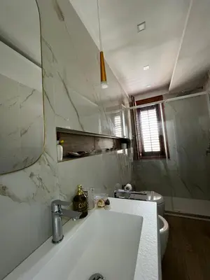 a bathroom with a sink and a mirror and a toilet at sicily home casa vacanze con piscina in San Vito lo Capo