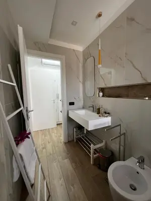 a white bathroom with a sink and a mirror at sicily home casa vacanze con piscina in San Vito lo Capo