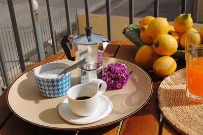 a table with a coffee maker and a cup of coffee at sicily home casa vacanze con piscina in San Vito lo Capo