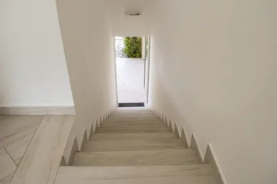 a hallway with white walls and a stairway at Borgo Aranci - Villetta a schiera Lavanda - A8 in Castellammare del Golfo
