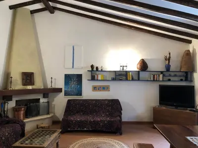 a living room with a couch and a tv at Villa Mariza in Scopello