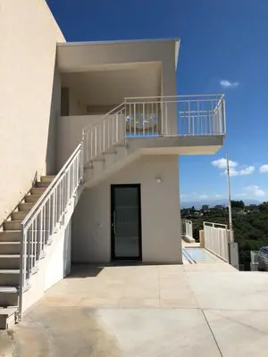 a house with a staircase and a balcony at Villa Vo' Scurá in Alcamo Marina