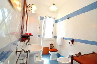 a bathroom with a sink and a toilet at Villa Calamazzo in Scopello