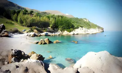 a body of water with rocks and a beach at Villa Calamazzo in Scopello
