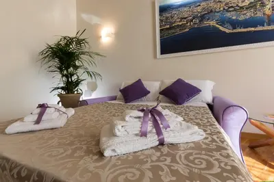 a room with a table with towels and a plant at SUITE 188 - Welcome in Palermo