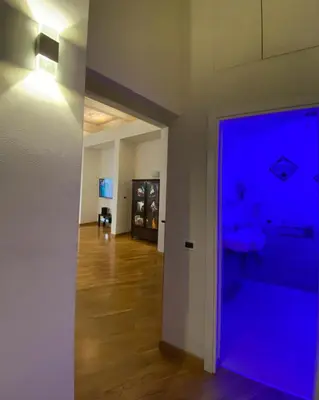 a hallway with a blue light on a wall at SUITE 188 - Welcome in Palermo