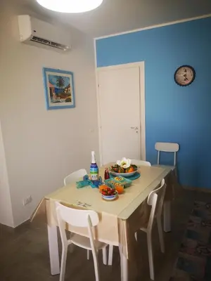 a dining room table with a bowl of fruit on it at Il Faro Casa Vacanze Design Privacy Comfort e Posto Auto in San Vito lo Capo