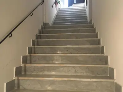 a stairway with grey concrete stairs and a stair case at Discesa Delle Capre Studio Confort in Palermo