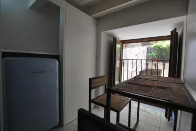 a room with a balcony with a table and a window at Discesa Delle Capre Studio Confort in Palermo
