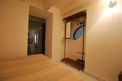 a bedroom with a bed and a door to a hallway at Discesa Delle Capre Studio Confort in Palermo