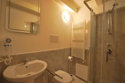 a bathroom with a sink and a toilet and a shower at Discesa Delle Capre Studio Confort in Palermo