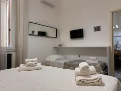 a hotel room with two towels on a bed at Aziz b&b in Palermo