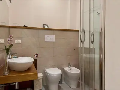 a bathroom with a sink and a toilet and a shower at Aziz b&b in Palermo