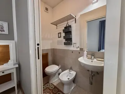 a bathroom with a toilet and a sink at Aziz b&b in Palermo