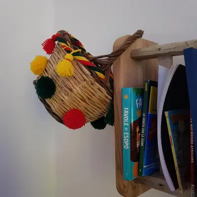 a book shelf with a basket and books at Aziz b&b in Palermo