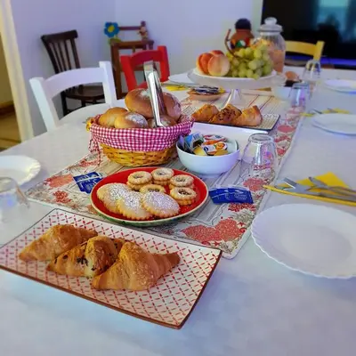 a table with plates of pastries and bowls of food at Aziz b&b in Palermo
