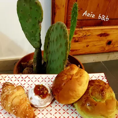 a plate of food with bread and a cactus at Aziz b&b in Palermo