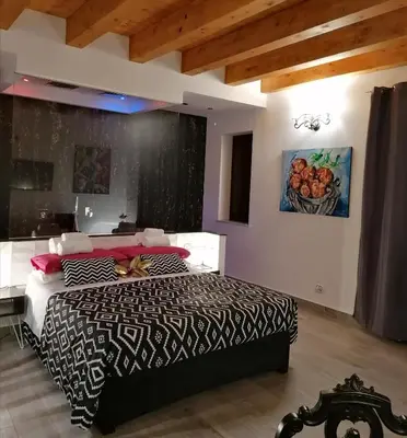 a bedroom with a bed with a black and white comforter at Casa Busari in Palermo