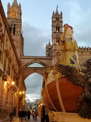 a statue of a woman sitting on a boat in front of a building at Casa Busari in Palermo