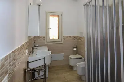 a bathroom with a sink and a toilet and a mirror at CASA 