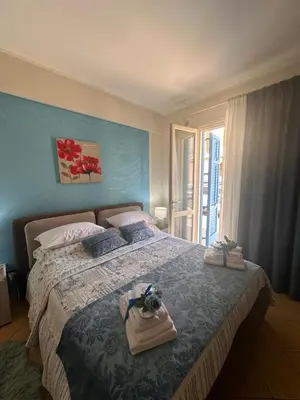 a bedroom with a bed with a bag on it at appartamento residence via giardini Acquamarina in San Vito lo Capo
