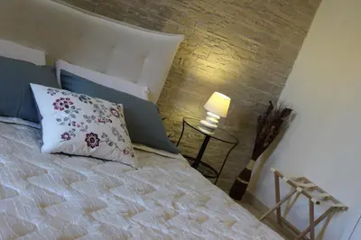 a bedroom with a bed and a brick wall at Ai Carrettieri della Cattedrale in Palermo