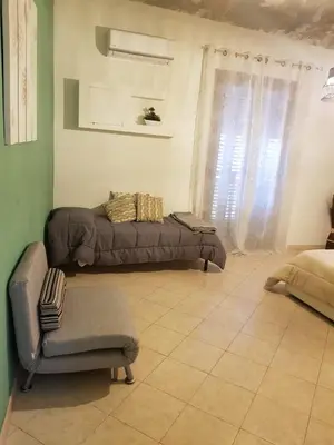 a living room with a couch and a chair at Ai Carrettieri della Cattedrale in Palermo