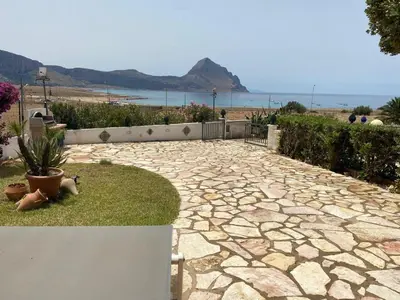 a stone walkway with a view of the ocean at Villa vista MARE a MÀKARI in San Vito lo Capo