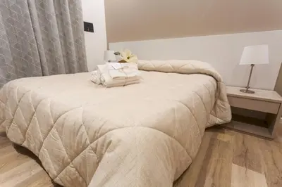 a bedroom with a bed with two pillows on it at Due Passi Suite in Palermo