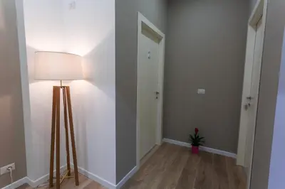 an empty hallway with a lamp and a door at Due Passi Suite in Palermo