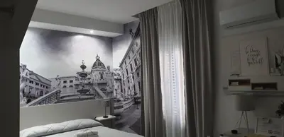 a bedroom with a picture of a city on the wall at Due Passi Suite in Palermo