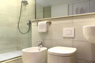a bathroom with a toilet and a sink and a shower at Hotel Egitarso Sul Mare in San Vito lo Capo