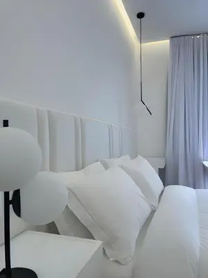 a bedroom with two beds with white pillows at Hotel Egitarso Sul Mare in San Vito lo Capo