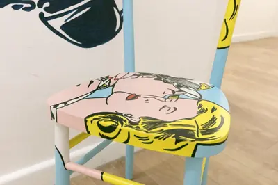 a chair with a painting of a man on it at Afea Art & Rooms in Palermo