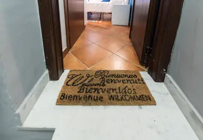 a welcome mat on the floor of a hallway at Kasavucciria Apartments in Palermo