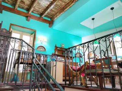a room with a staircase and blue walls at Vittorio Emanuele Rooms di Prinzi in Palermo