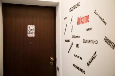 a door with a sign on it with a welcome sign on it at Casa Palazzo Reale in Palermo