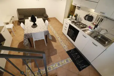 a kitchen and dining room with a table and a stove at Casa Palazzo Reale in Palermo
