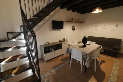 a living room with a table and a couch at Casa Palazzo Reale in Palermo