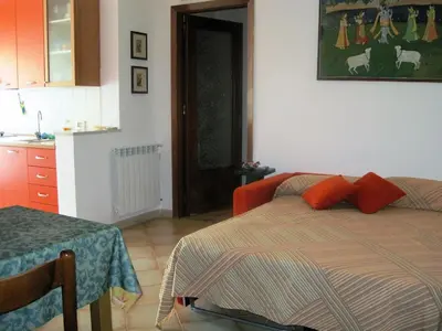 a bedroom with a bed with red pillows on it at Appartamento Libertà in Palermo