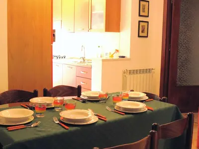 a table with plates and dishes on a green table cloth at Appartamento Libertà in Palermo
