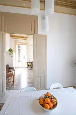 a bowl of oranges on a table in a room at Aria Rooms in Palermo