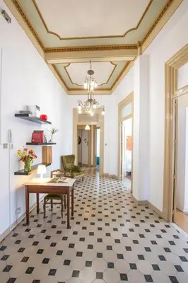 a dining room with a table and a ceiling at Aria Rooms in Palermo