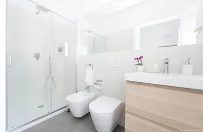 a bathroom with a toilet and a shower and a sink at Dimora CentroWell in Palermo