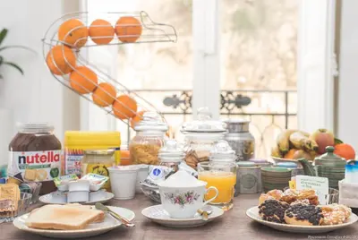 a table topped with plates of breakfast foods and coffee at Dimora CentroWell in Palermo