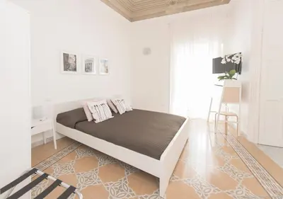 a white bedroom with a large bed in a room at Dimora CentroWell in Palermo