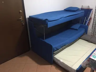 two bunk beds in a room with a door at 