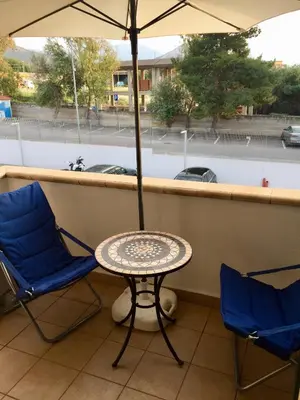 a table and two chairs and an umbrella on a balcony at 