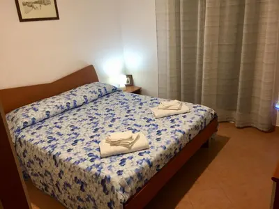 a bedroom with a bed with two shoes on it at 