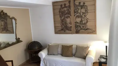 a living room with a white couch and a mirror at Penthouse Luxury Quattro Canti in Palermo